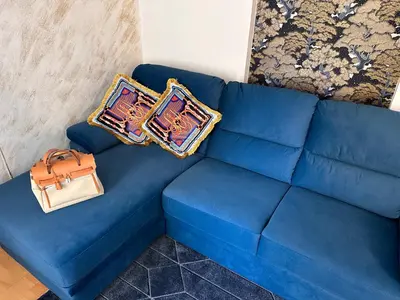 a blue couch with two pillows and a purse on it at PARIOLI LUXURY SUITe II in Rome