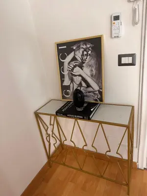 a glass table with a picture on the wall at PARIOLI LUXURY SUITe II in Rome