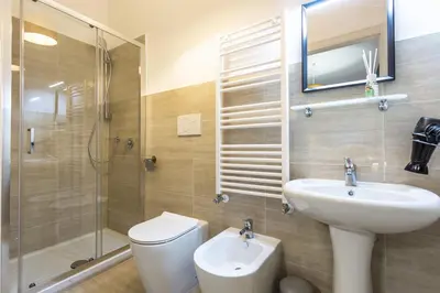 a bathroom with a sink and a toilet and a shower at Ethnos Relais Vaticano in Rome