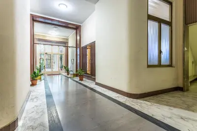 an empty hallway with potted plants in a building at Ethnos Relais Vaticano in Rome