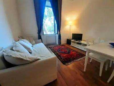 a living room with a white couch and a table at Vaticano Ferrari Apartment in Rome
