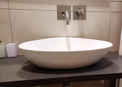 a white bowl sink on a counter in a bathroom at Vaticano Ferrari Apartment in Rome