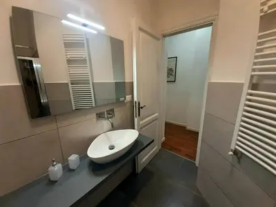 a bathroom with a sink and a mirror at Vaticano Ferrari Apartment in Rome