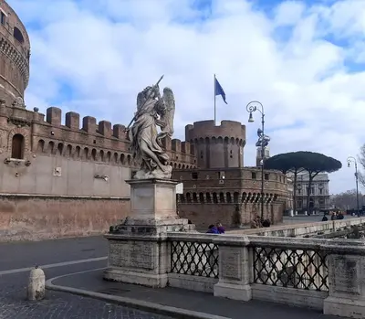 a statue on a bridge in front of a castle at Vaticano Ferrari Apartment in Rome