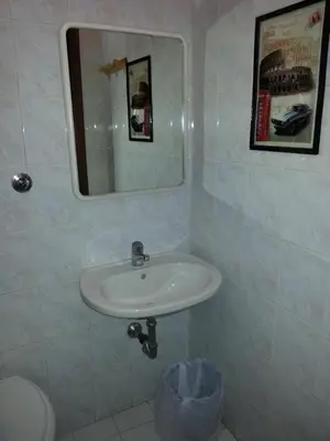 a bathroom with a sink and a mirror at Roxena house in Rome