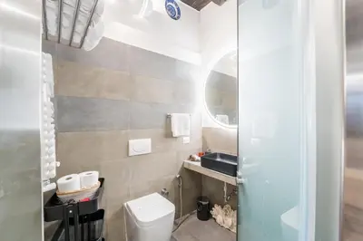 a bathroom with a toilet and a sink at Intimo ed Eclettico Studio a Trastevere in Rome
