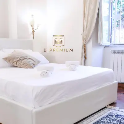 a white bed in a white room with a mattress at Bpremium apartment in Rome