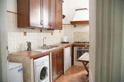 a kitchen with a sink and a washing machine at Bpremium apartment in Rome