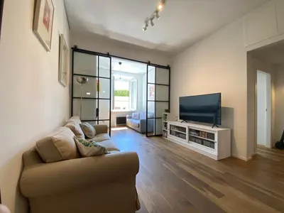 a living room with a couch and a flat screen tv at Leopardi Sweet Home in Rome