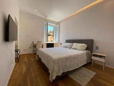 a bedroom with a bed and a flat screen tv at Leopardi Sweet Home in Rome