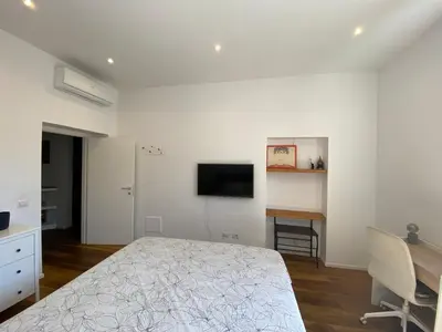 a bedroom with a bed and a desk and a television at Leopardi Sweet Home in Rome