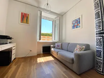 a living room with a couch and a window at Leopardi Sweet Home in Rome