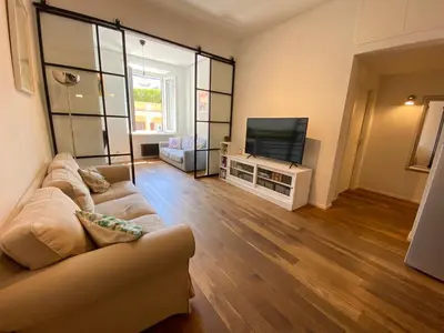 a living room with a couch and a flat screen tv at Leopardi Sweet Home in Rome