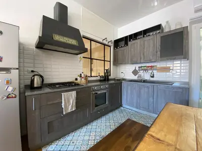 a kitchen with blue cabinets and a refrigerator at Leopardi Sweet Home in Rome