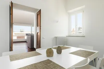 a white room with a table with two vases on it at Nikis Maison Navona - 4th floor no elevator in Rome