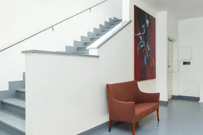 a chair in a room with a staircase at Nikis Maison Navona - 4th floor no elevator in Rome