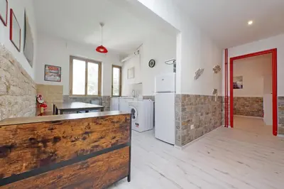 a large kitchen with a counter in a room at Lucky Domus Appio in Rome