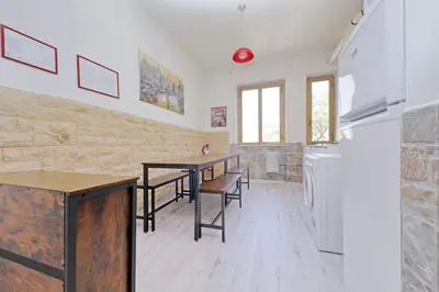 a dining room with a table and a refrigerator at Lucky Domus Appio in Rome