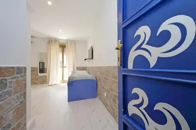 a blue door in a bathroom with a toilet at Lucky Domus Appio in Rome