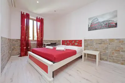 a bedroom with a bed and a brick wall at Lucky Domus Appio in Rome