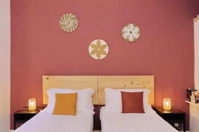 two beds in a room with red walls at Flatinrome Trastevere 2 - Jacuzzi in Trastevere in Rome