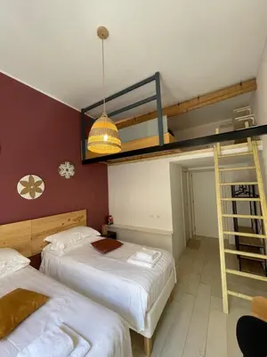 two beds in a room with a bunk bed at Flatinrome Trastevere 2 - Jacuzzi in Trastevere in Rome