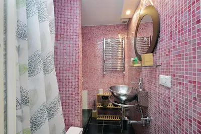 a bathroom with a sink and pink tiles at Flatinrome Trastevere 2 - Jacuzzi in Trastevere in Rome