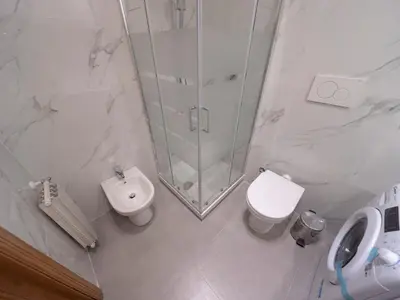 a bathroom with a shower and a toilet and a sink at Spanish Steps, Suite Dominic, Strollingrome in Rome