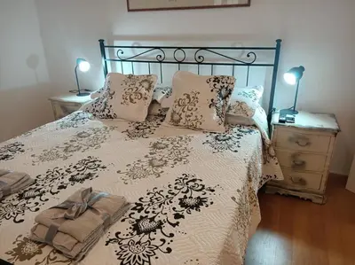 a bed with a black and white comforter and pillows at CasaLara Garden in Rome