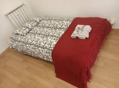 a bed with two towels on top of it at CasaLara Garden in Rome