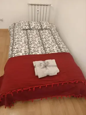a bed with a red blanket with a bow on it at CasaLara Garden in Rome