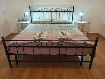 a bedroom with a large bed with two night stands at CasaLara Garden in Rome