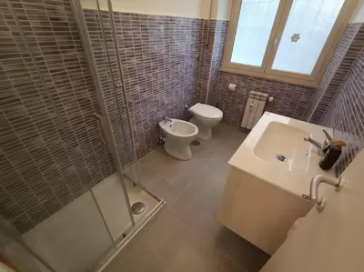 a bathroom with a shower and a toilet and a sink at CasaLara Garden in Rome
