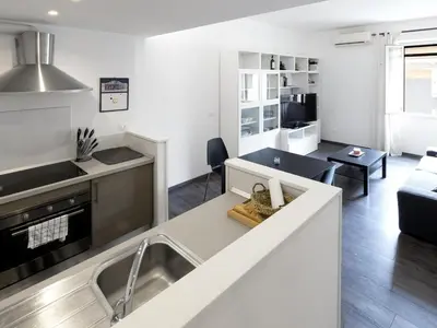 a kitchen and living room with a couch and a table at Apartment Pratolina by Interhome in Rome