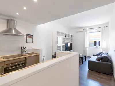 a kitchen and living room with a couch and a table at Apartment Pratolina by Interhome in Rome