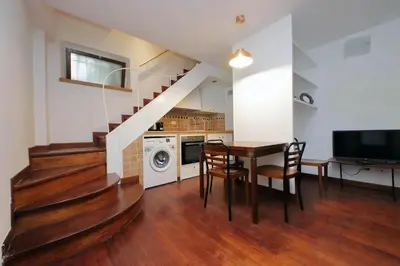 a kitchen and dining room with a table and stairs at Colosseo Family Apartment Capo d'Africa AC/wifi in Rome