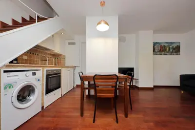 a kitchen and dining room with a table and a washing machine at Colosseo Family Apartment Capo d'Africa AC/wifi in Rome