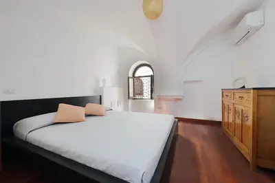 a bedroom with a bed with two pillows on it at Colosseo Family Apartment Capo d'Africa AC/wifi in Rome