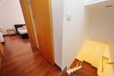 a hallway with a stairway leading to a living room at Colosseo Family Apartment Capo d'Africa AC/wifi in Rome