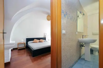 a bedroom with a bed and a sink in a room at Colosseo Family Apartment Capo d'Africa AC/wifi in Rome