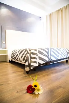 a bedroom with a bed with flowers on the floor at Modern BnB in Rome