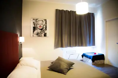 a bedroom with a bed and a picture of a woman at Modern BnB in Rome