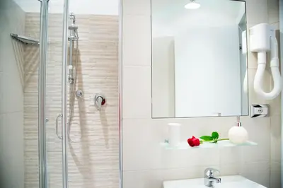 a bathroom with a sink and a shower with a mirror at Modern BnB in Rome
