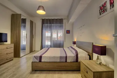 a bedroom with a bed and a tv and a window at Madì B&B in Rome