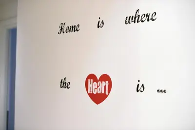 a wall with hearts and words on it at Madì B&B in Rome