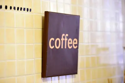 a sign that says coffee hanging on a wall at Madì B&B in Rome
