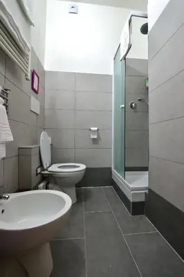 a bathroom with a toilet and a sink and a shower at Madì B&B in Rome
