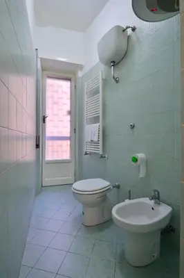 a bathroom with a toilet and a sink at Madì B&B in Rome