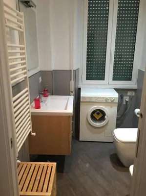 a small bathroom with a sink and a washing machine at Bed & Puppets in Rome