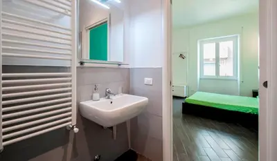 a bathroom with a sink and a bed at Bed & Puppets in Rome